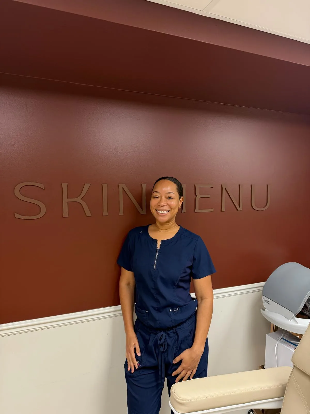 Alesha, Skin & Laser Therapist, at the SKINMENU wall